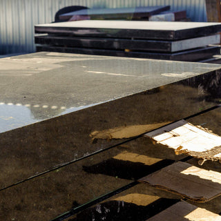 Marble and granite slabs for making tombstones in a warehouse