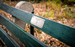 a plaque on a memorial bench