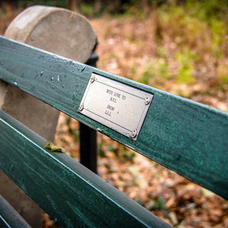 a plaque on a memorial bench