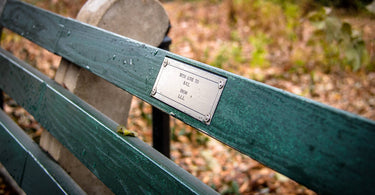 a plaque on a memorial bench