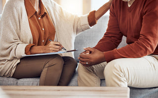 two people sitting down in a couch during a therapy session