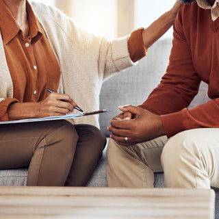 two people sitting down in a couch during a therapy session