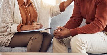 two people sitting down in a couch during a therapy session