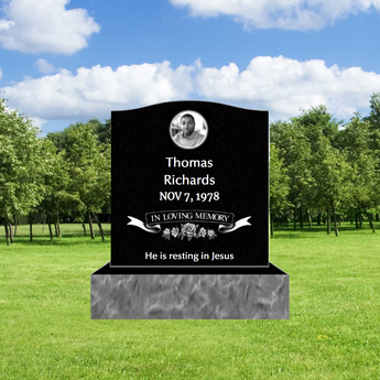 black granite single monument headstone with a head shot photo, name, date, a floral graphic that says "in loving memory" and an epitaph.