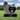 Carved Angel hugging a Single Black Granite Heart Headstone. In the heart is a last name, and the words "in loving memory", on the base is a first name, middle initial, birth and death date.