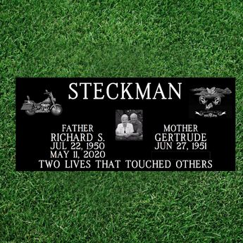 companion grass level black granite headstone with a last name in between 2 upper corner graphics, names and dates on either side of a couples photo, and an epitaph at the bottom