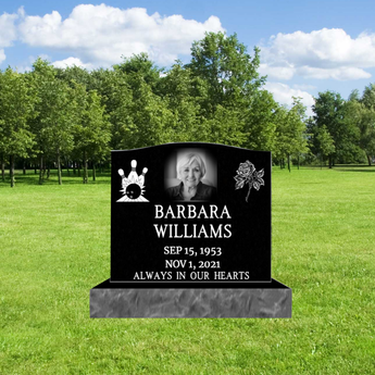 black granite headstone with 2 graphics on each corner, a headshot photo, a name, birth date and death date, and epitaph