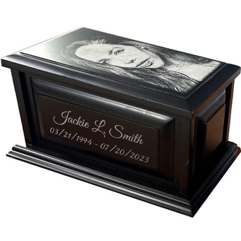 Dark wood Urn with a headshot photo on top, a name on the front with a birthdate and death date underneath the name